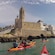 Kayakers paddling in the waters fronting a cathedral